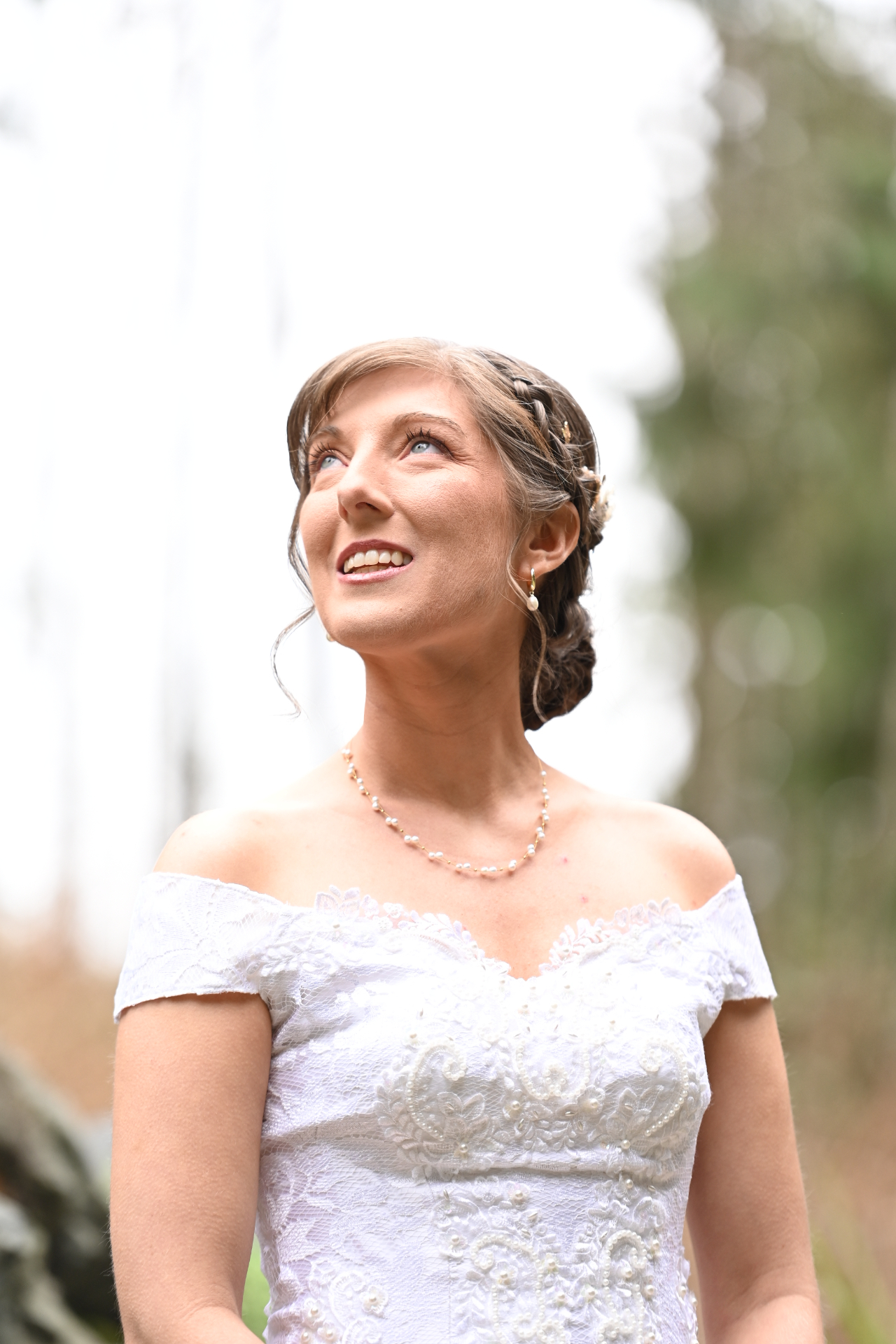 Bride looking up joyfully in soft natural light